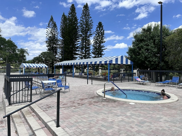 3206 Carambola Cir S, Coconut Creek, FL 33066 - view of pool with fence and a community hot tub