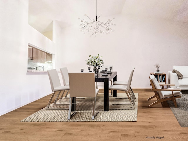 3206 Carambola Cir S, Coconut Creek, FL 33066 - dining space featuring a chandelier, wood finished floors, and a high ceiling