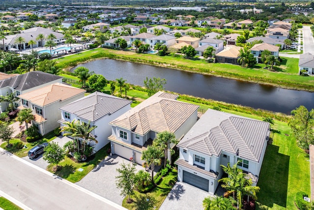 aerial view of residential area featuring a large body of water