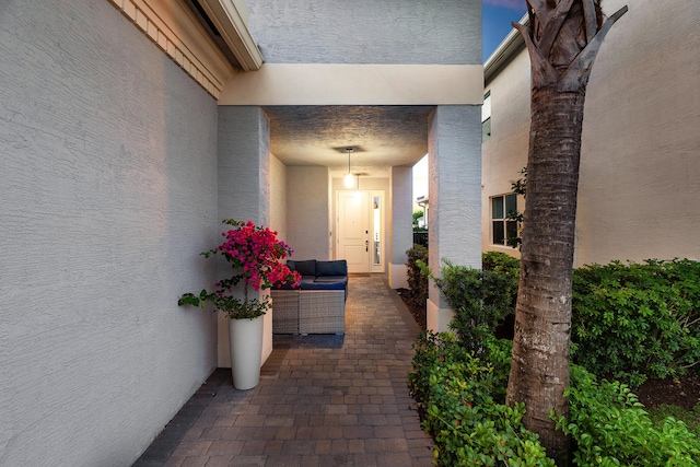 property entrance with stucco siding and an outdoor hangout area