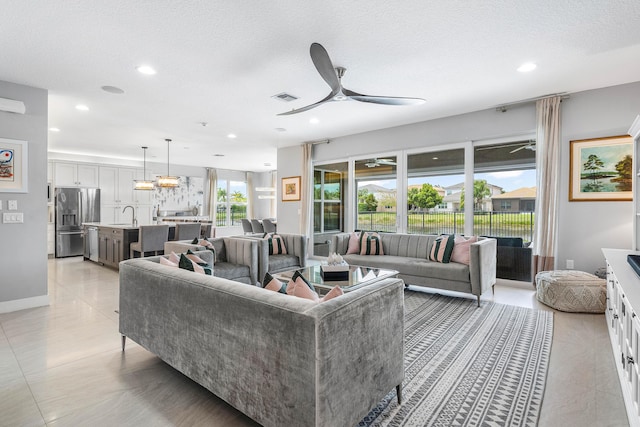 living room featuring a ceiling fan, light tile patterned floors, and recessed lighting