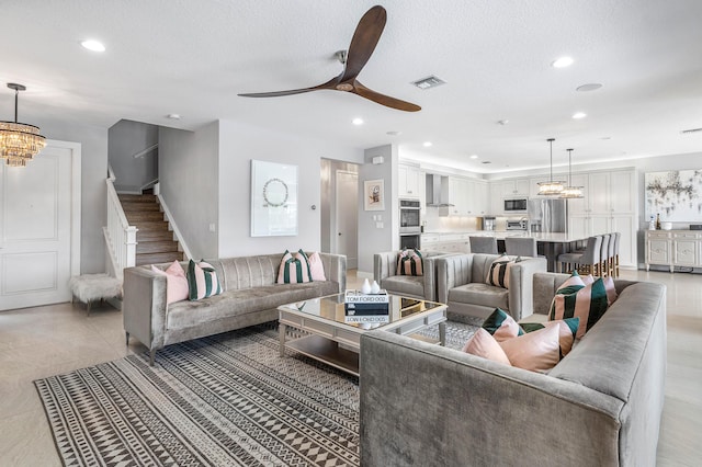 living room featuring a chandelier, stairs, recessed lighting, a ceiling fan, and light tile patterned flooring
