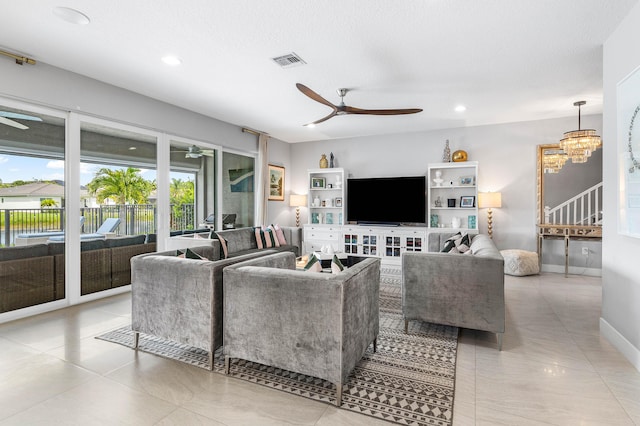 living area with a ceiling fan, recessed lighting, light tile patterned floors, a chandelier, and baseboards
