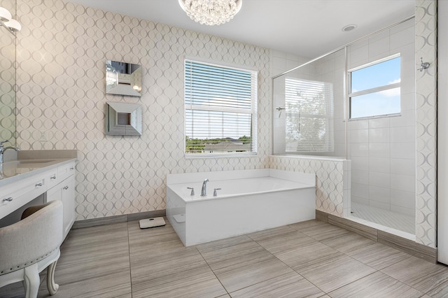 full bath featuring walk in shower, tile patterned floors, a garden tub, wallpapered walls, and a chandelier