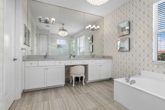 full bathroom with wallpapered walls, a chandelier, a stall shower, a garden tub, and healthy amount of natural light