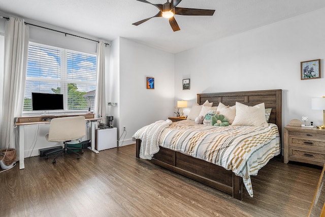 bedroom featuring wood finished floors, an office area, and ceiling fan