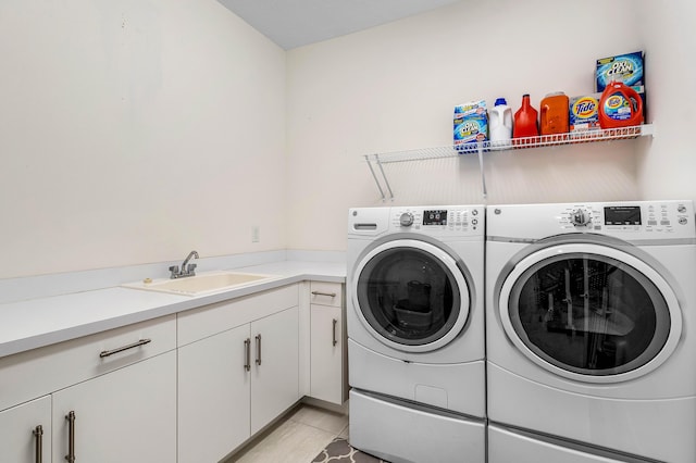 clothes washing area featuring a sink, washing machine and dryer, and light tile patterned floors