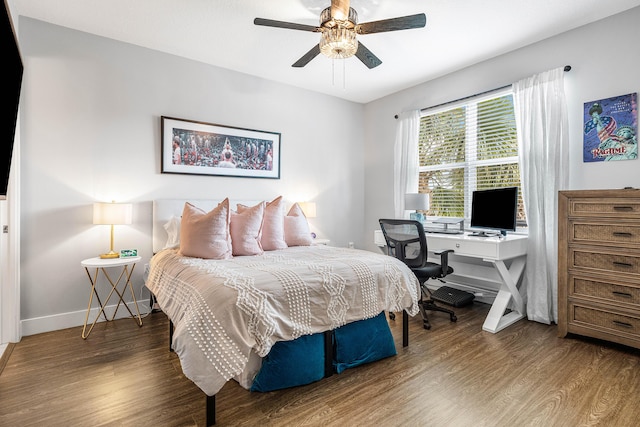 bedroom with wood finished floors, baseboards, a desk, and a ceiling fan
