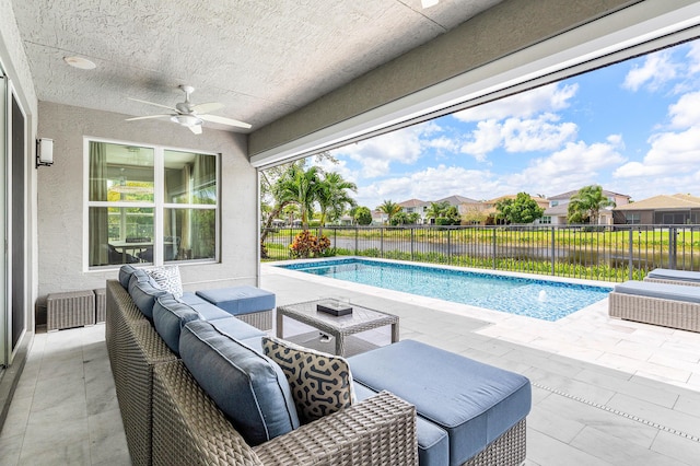 view of pool featuring ceiling fan, outdoor lounge area, a fenced backyard, and a patio
