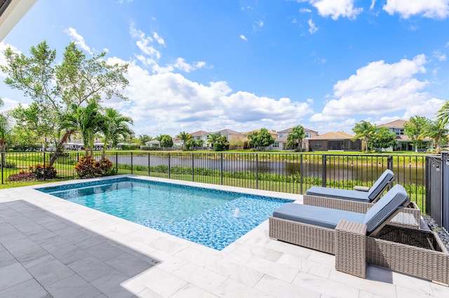 view of pool with a water view, a patio area, and a fenced backyard