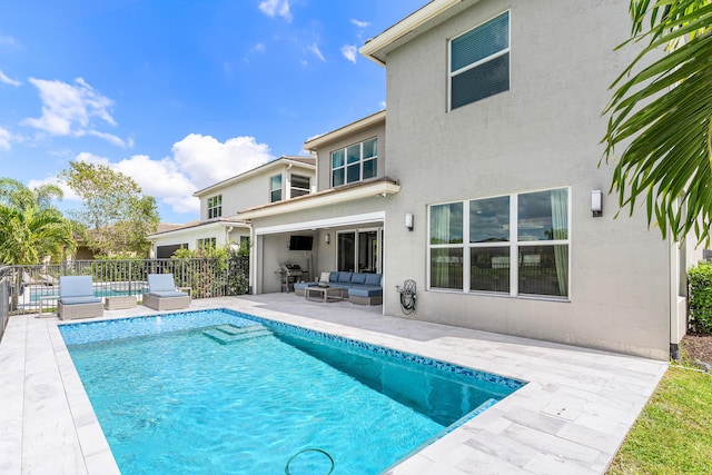 view of pool featuring an outdoor living space, fence, and a patio area