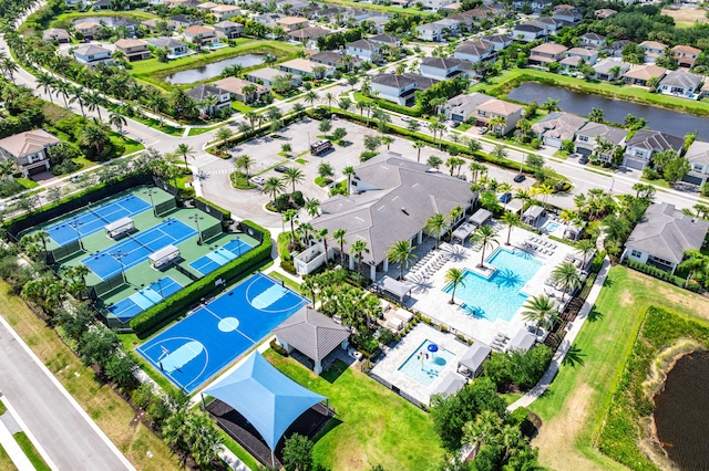 aerial view of residential area with a pool and a nearby body of water