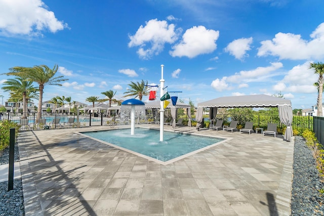 community pool featuring fence and a gazebo