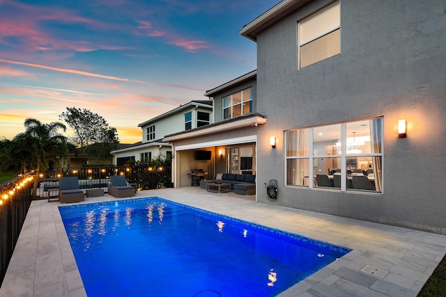 rear view of house with an outdoor living space, stucco siding, and a patio area