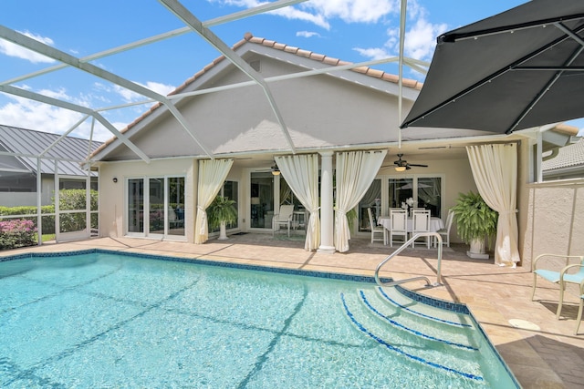 swimming pool with ceiling fan, a patio, and a lanai