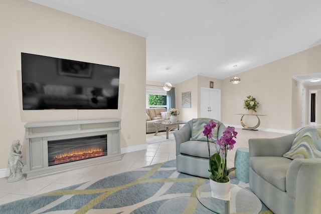 living room featuring tile patterned flooring, a glass covered fireplace, and baseboards
