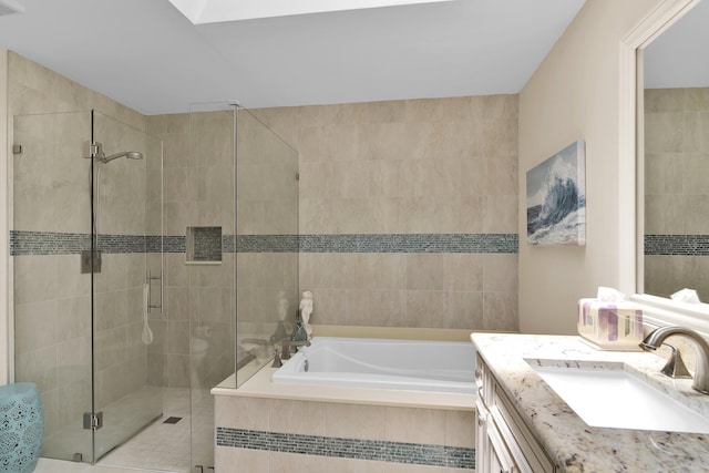 bathroom featuring a shower stall, a garden tub, and vanity
