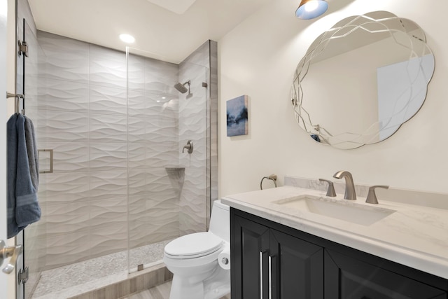 full bath featuring toilet, a shower stall, vanity, and recessed lighting