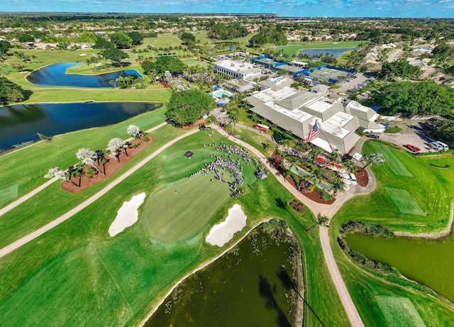 aerial view of property and surrounding area featuring a large body of water and a local golf course