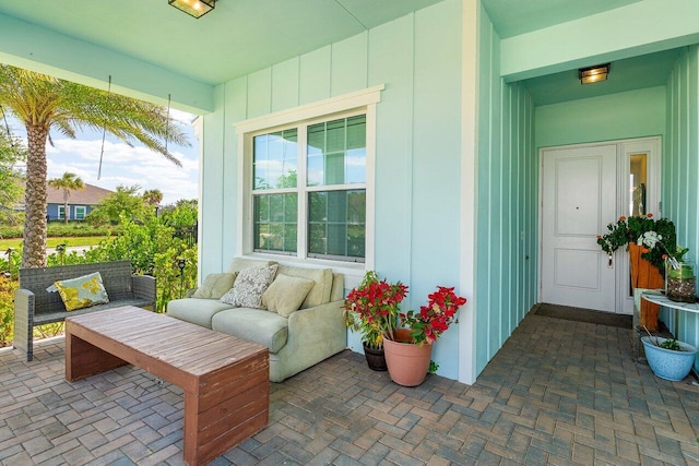 exterior space featuring board and batten siding and outdoor lounge area