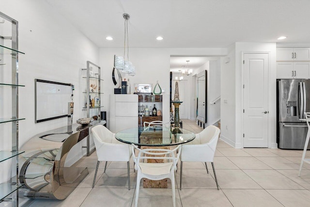 dining area featuring recessed lighting, light tile patterned flooring, and a notable chandelier