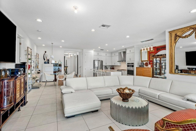 living area with visible vents, recessed lighting, and light tile patterned floors