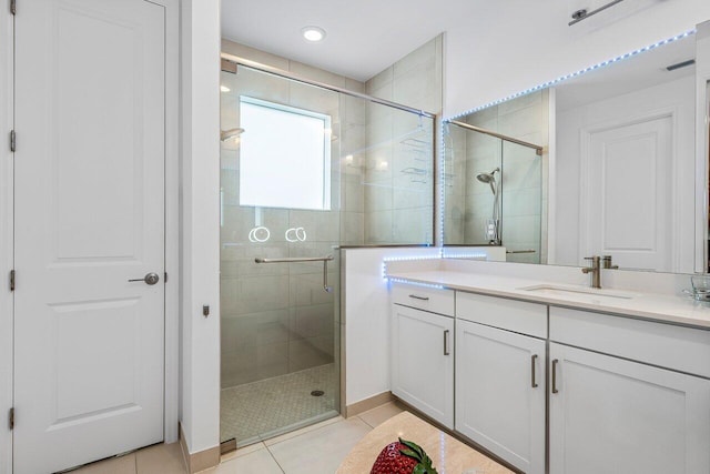 bathroom featuring vanity, tile patterned floors, a stall shower, and recessed lighting