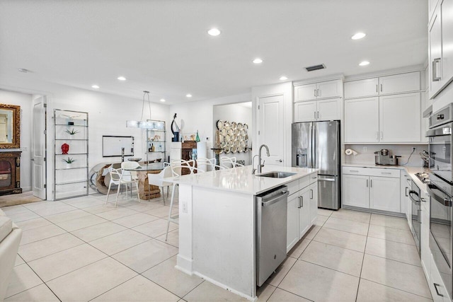 kitchen with a sink, appliances with stainless steel finishes, recessed lighting, and visible vents