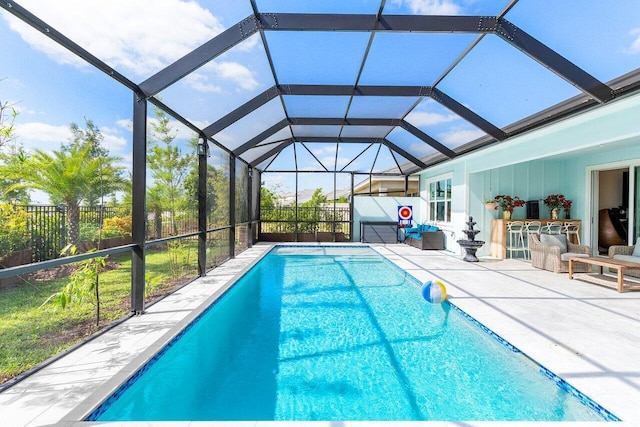 view of swimming pool with fence, a fenced in pool, a lanai, and a patio area