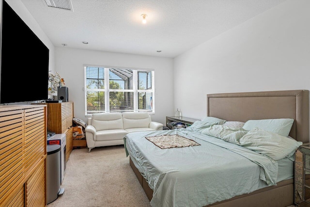 bedroom featuring light carpet and visible vents