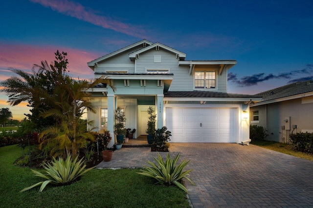 view of front facade with an attached garage and decorative driveway