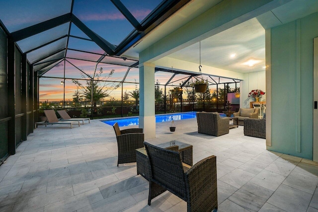 patio terrace at dusk featuring glass enclosure, an outdoor living space, and an outdoor pool
