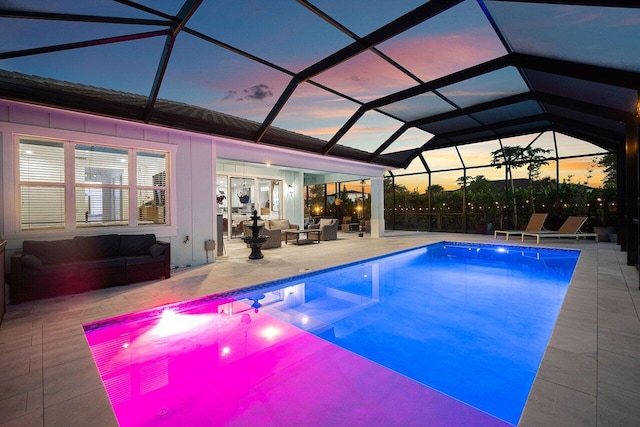 outdoor pool featuring glass enclosure, a patio area, french doors, and an outdoor hangout area