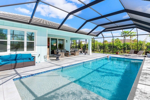 pool with glass enclosure, a patio, and an outdoor hangout area
