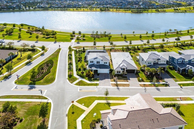 drone / aerial view with a water view and a residential view