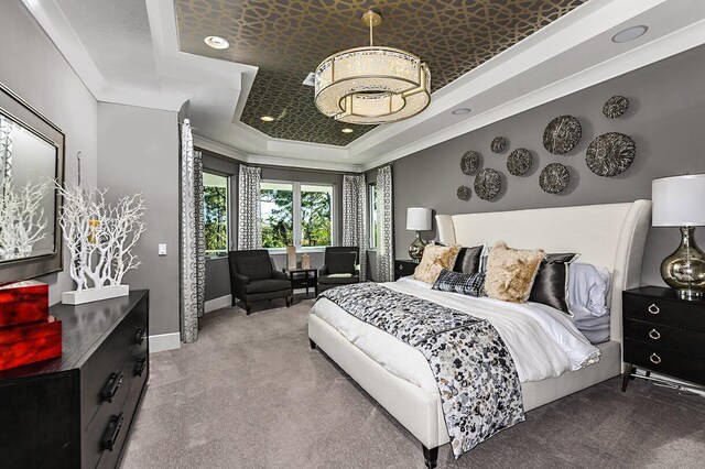 carpeted bedroom with a raised ceiling, baseboards, and recessed lighting