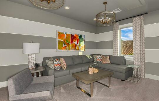 carpeted living room featuring recessed lighting, baseboards, and an inviting chandelier