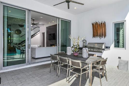 view of patio / terrace with a ceiling fan, outdoor dining area, and area for grilling