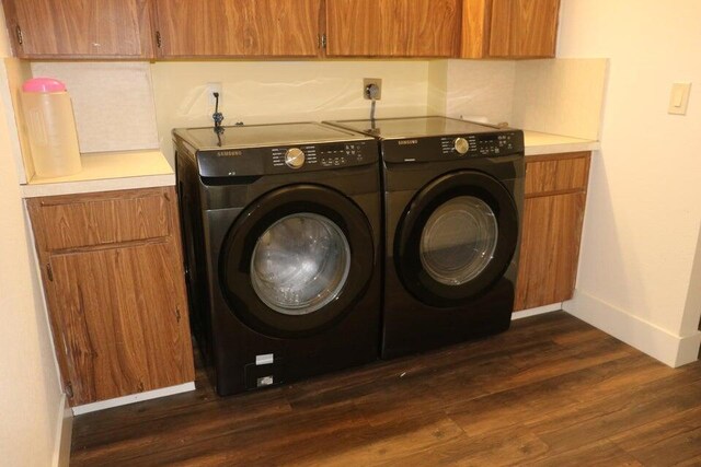 3710 Whitehall Dr Unit 304, West Palm Beach, FL 33401 - washroom with washing machine and dryer, cabinet space, baseboards, and dark wood-style floors