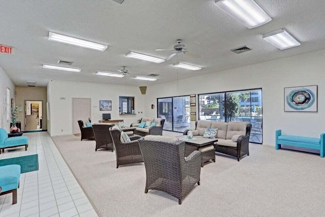 3710 Whitehall Dr Unit 304, West Palm Beach, FL 33401 - carpeted living area with tile patterned floors, a ceiling fan, and a textured ceiling
