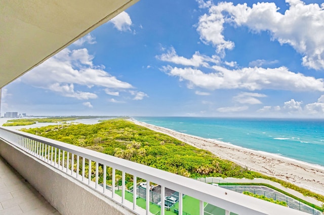 balcony featuring a water view and a view of the beach