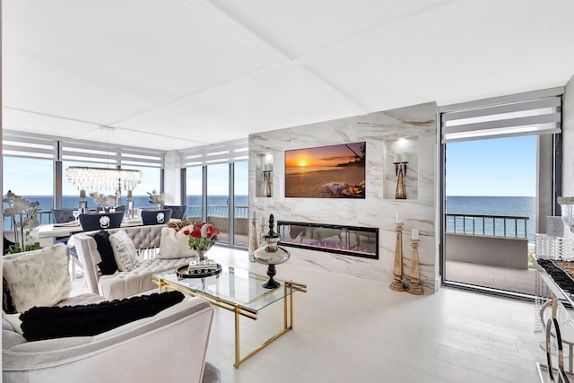 living area featuring a wall of windows, a fireplace, and a wealth of natural light