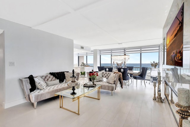 living area with a notable chandelier, floor to ceiling windows, and visible vents