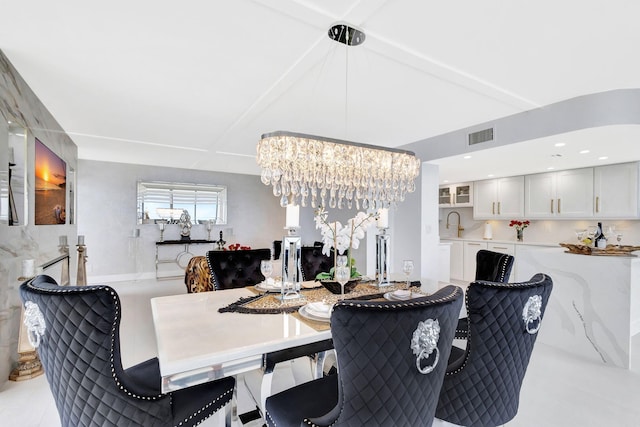 dining area with visible vents and a chandelier
