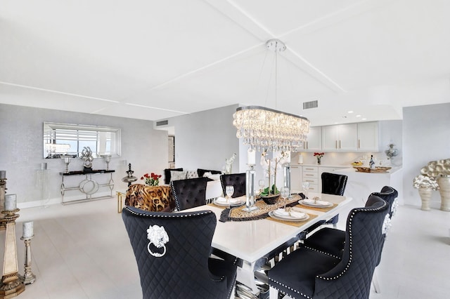 dining room with visible vents, a notable chandelier, and beamed ceiling