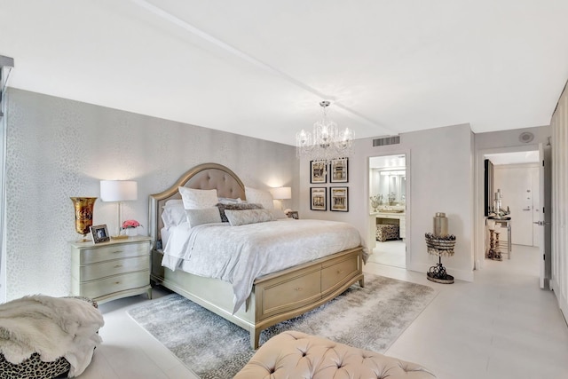 bedroom with a notable chandelier, visible vents, and ensuite bath