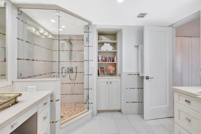 bathroom featuring tile patterned floors, recessed lighting, tile walls, visible vents, and a stall shower
