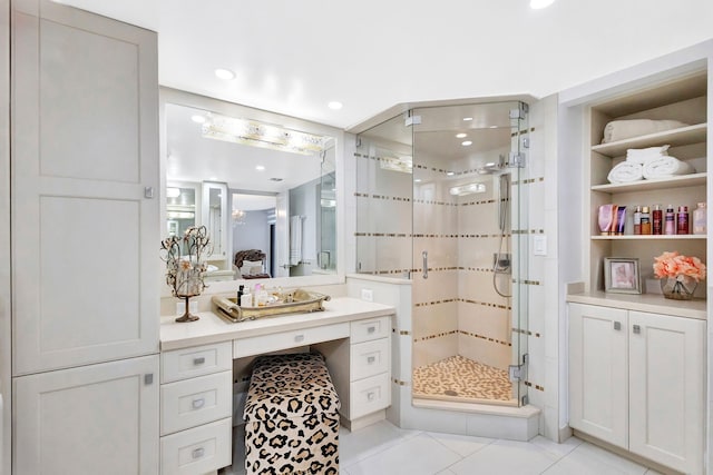 full bath featuring tile patterned flooring, recessed lighting, vanity, and a shower stall