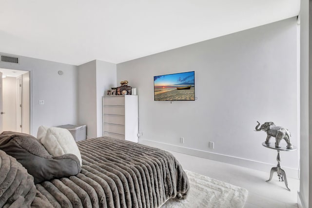 bedroom with baseboards and visible vents