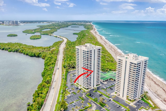drone / aerial view featuring a beach view and a water view